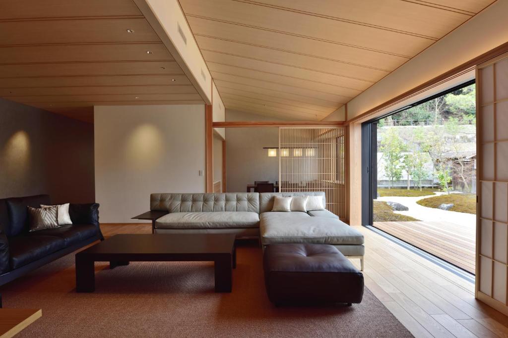 a living room with a couch and a table at Aoi Suites at Nanzenji Modern & Traditional Japanese Style in Kyoto