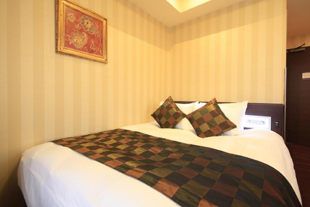 Postel nebo postele na pokoji v ubytování Hotel Coco Grand Kitasenju