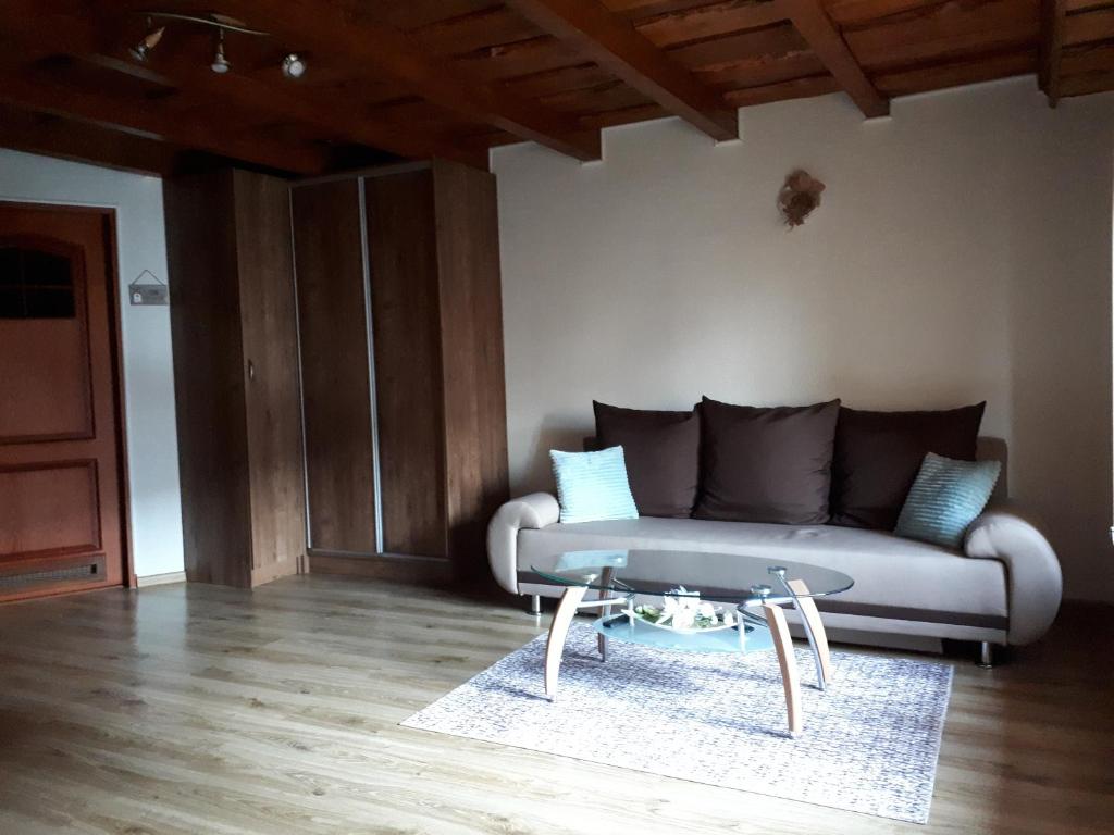 a living room with a couch and a table at Apartmán Bianka in Rabča