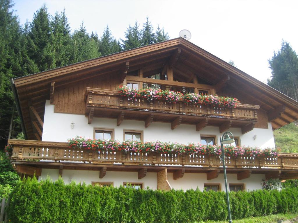 a house with a balcony with flowers on it at Alberta's Ferienhaus in Heinfels