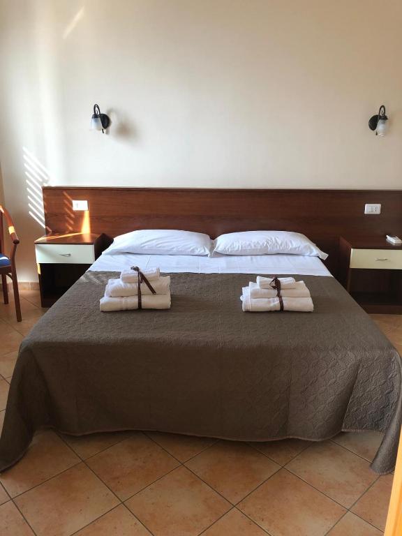 a bedroom with a bed with two towels on it at Case Vacanze Ancora in Porto Empedocle