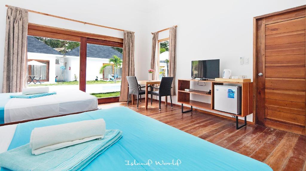 Postel nebo postele na pokoji v ubytování Island World Panglao