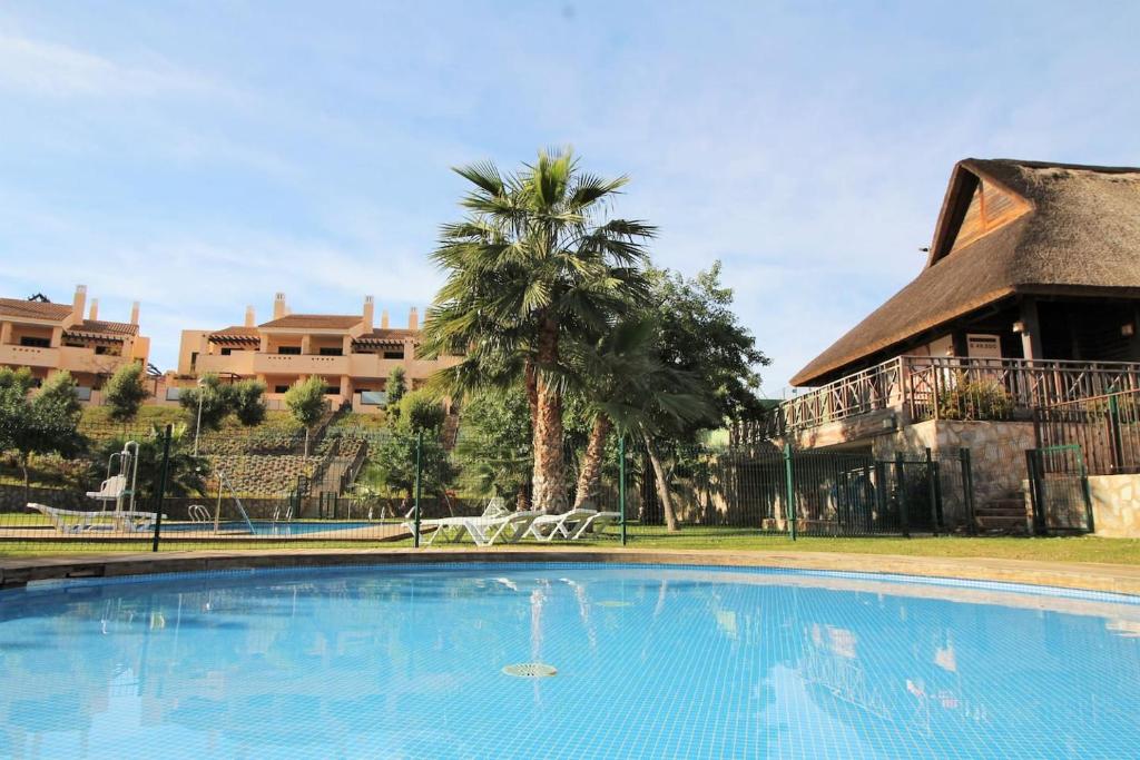 a large swimming pool in front of a building at The Oasis in Fuente Alamo