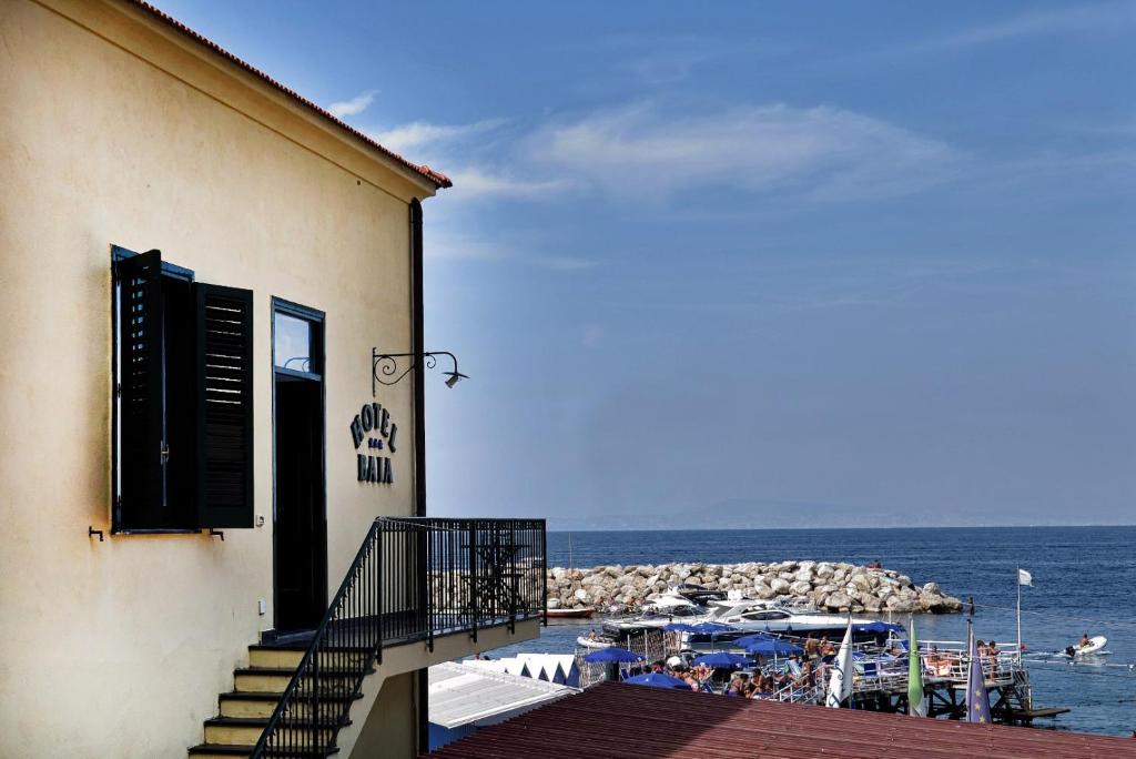 a balcony of a building with a view of the ocean at Hotel Baia Di Puolo in Massa Lubrense