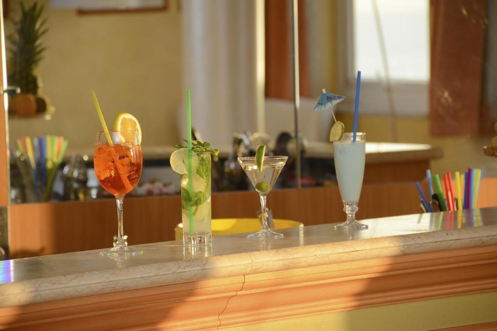 a counter with four different cocktails on it at Hotel Capizzo in Ischia