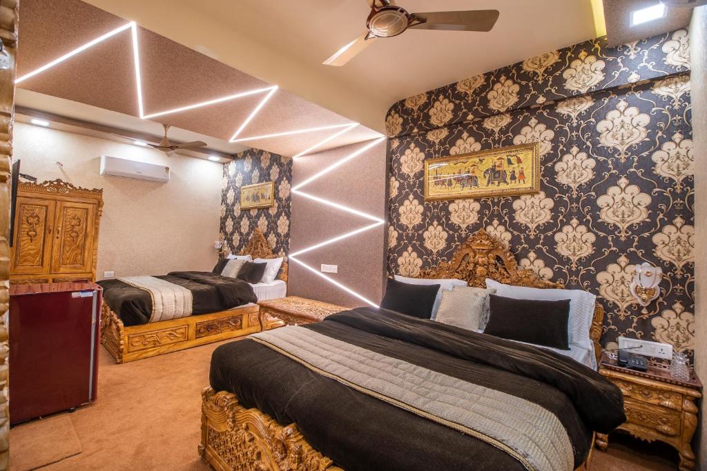 a bedroom with two beds in a room with wallpaper at Onn Shelter Inn in Mumbai