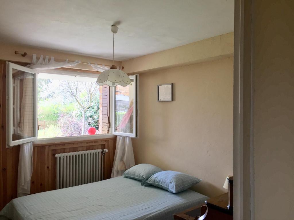 シャルネ・レ・マコンにあるChambre avec vue sur jardinのベッドルーム(ベッド1台、窓付)
