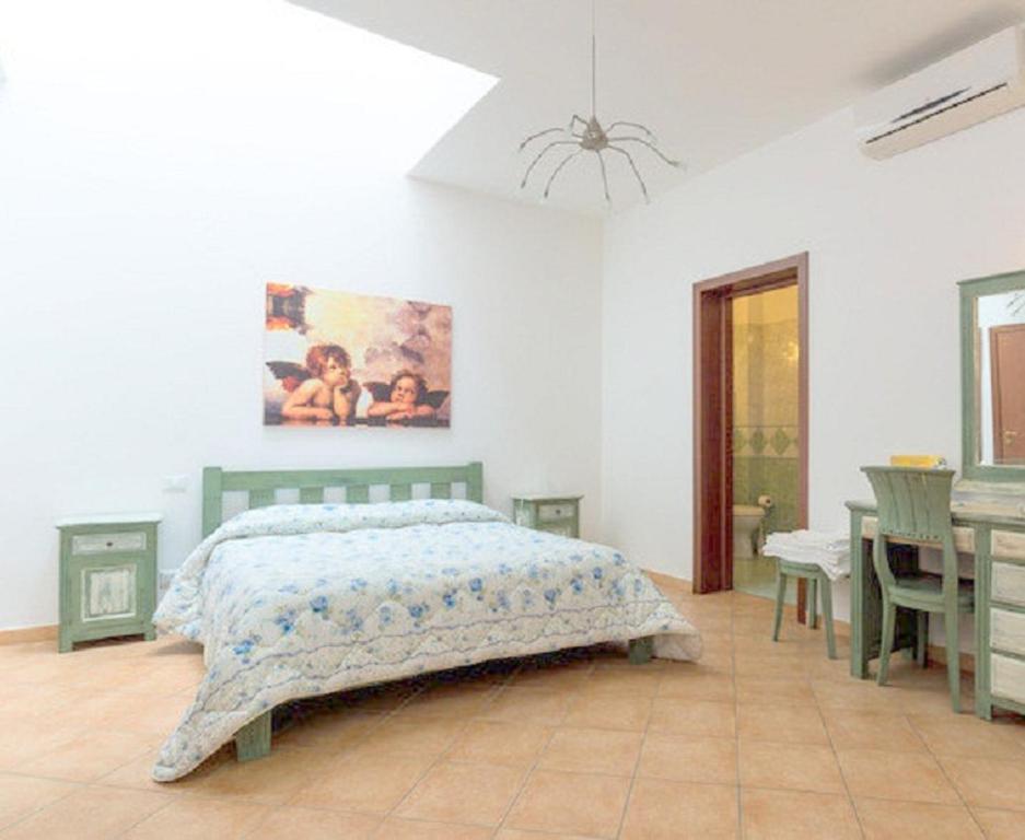 a bedroom with a bed and a desk in it at Renda Apartments in Trapani