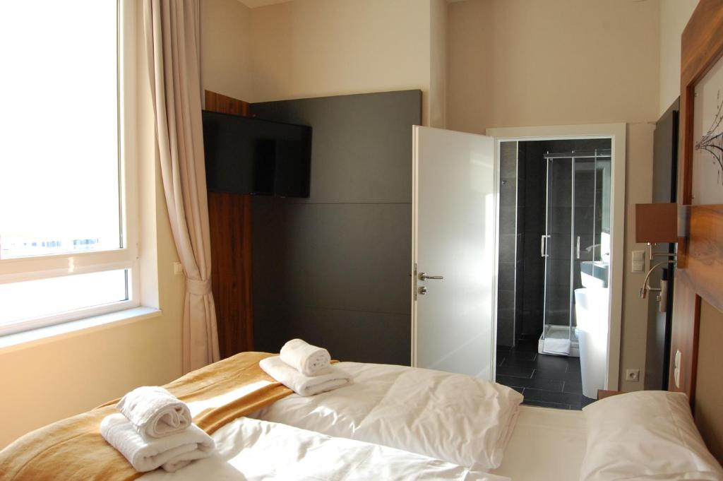 Postel nebo postele na pokoji v ubytování Apollo Hotel Vienna