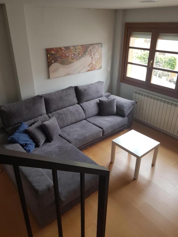 - un salon avec un canapé et une table dans l'établissement Apartamento Castillo de Arguedas, à Arguedas