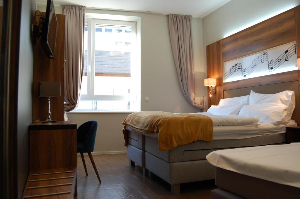 Postel nebo postele na pokoji v ubytování Apollo Hotel Vienna
