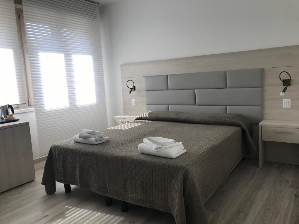 Postel nebo postele na pokoji v ubytování Il Sole e la Luna B&B in Garda