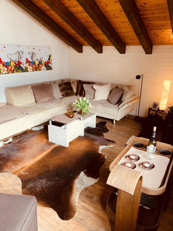 a living room with a couch and a table at Chalet Memory in Zermatt