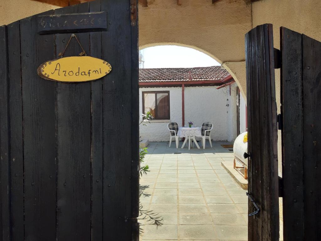 an entrance to a house with a sign on a door at ARODAFNI HOUSE. Unique views and amazing sunsets. in Kouklia