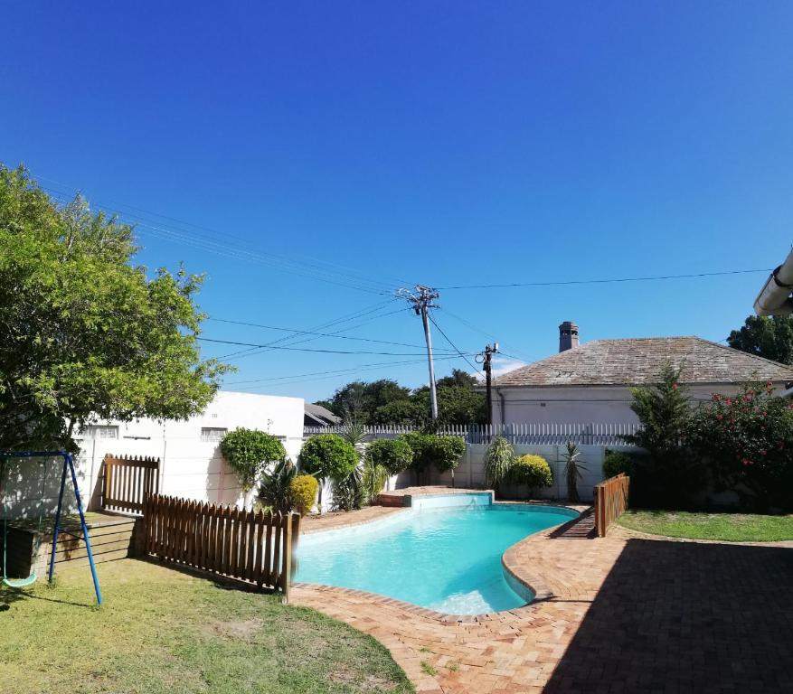 a swimming pool in the yard of a house at Coons Cove in Cape Town