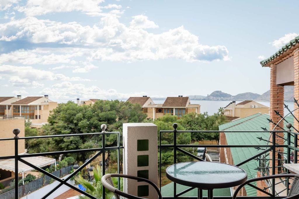 a balcony with a table and a view of the water at Hotel Boutique Calas de Alicante in Alicante
