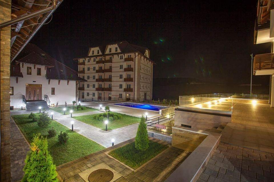 a view of a building with a courtyard at night at Zlatibor Hills 31 in Zlatibor