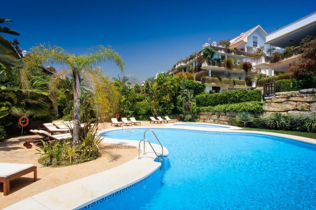 a swimming pool in front of a building at Lomas del Rey in Marbella