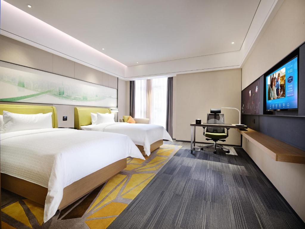 TV a/nebo společenská místnost v ubytování Hampton by Hilton Guangzhou Dongxiaonan