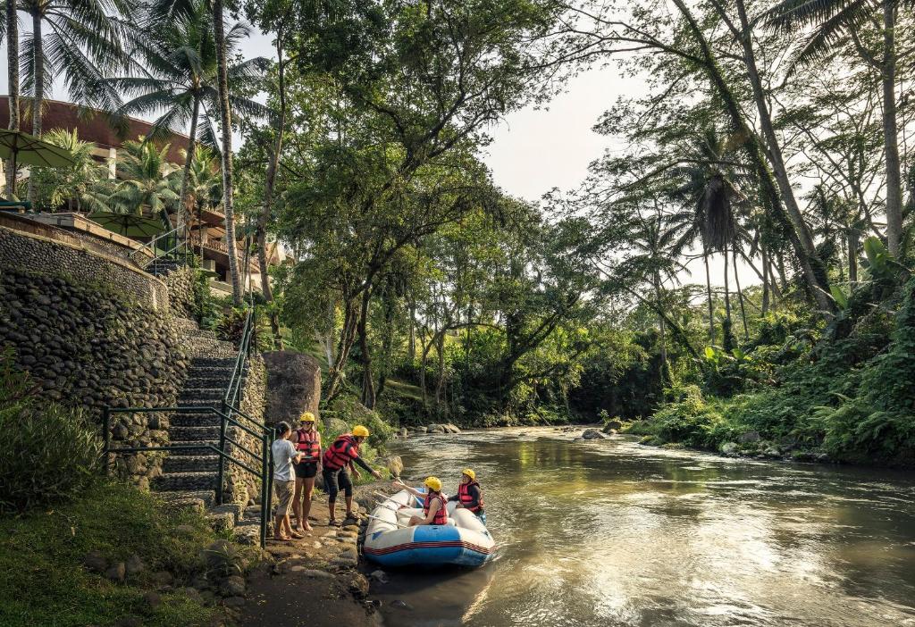 a group of people on a raft in a river at Four Seasons Resort Bali at Sayan in Ubud