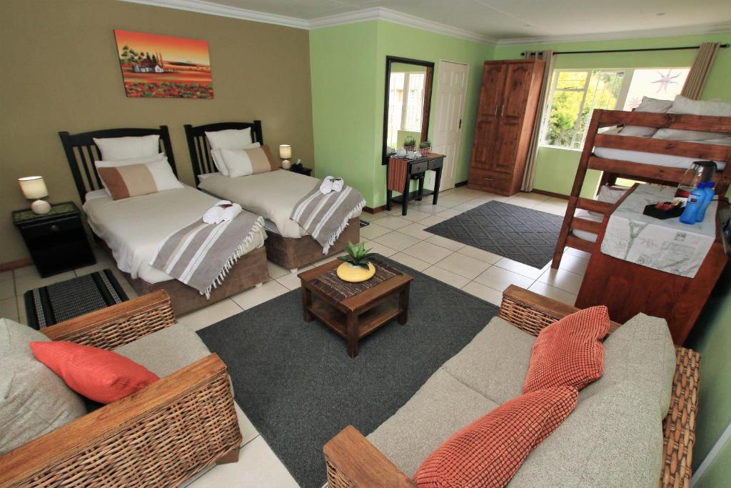 a living room with two beds and a couch at Summer Garden Guest House (Urban Jungle) in Benoni