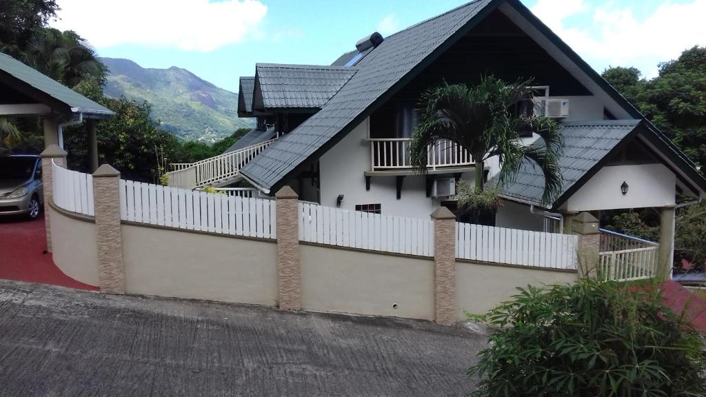 a house with a white fence in front of it at SHAY LYAH SELF CATERING in Victoria