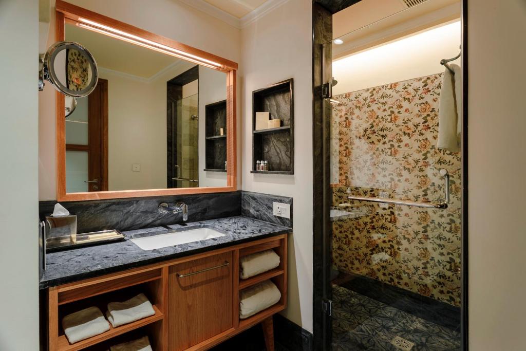 a bathroom with a sink and a shower at Taj Theog Resort & Spa Shimla in Shimla