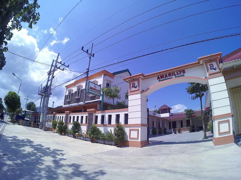 a building with an arch in front of a street at Amaryllis Guesthouse Syariah in Pacitan