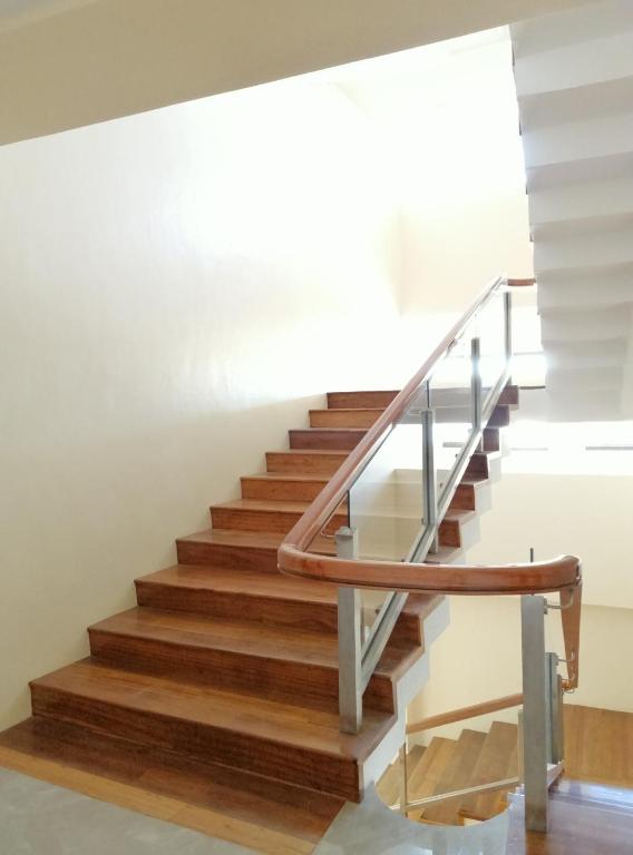 a staircase with wood and metal railings at PROXY by The Oriental Albay in Legazpi