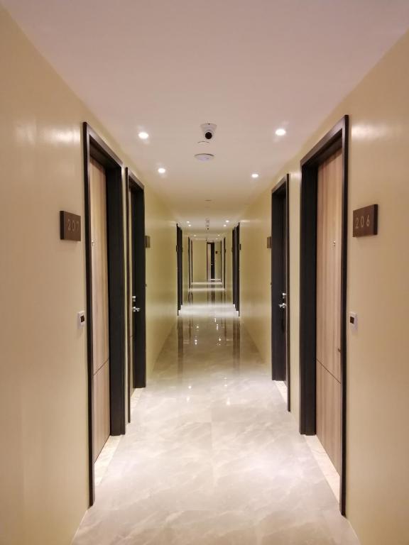 a corridor in a hotel with doors open at PROXY by The Oriental Albay in Legazpi