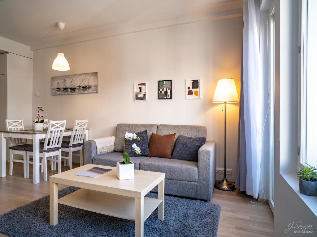 a living room with a couch and a table at Westbay Inn in Vaasa