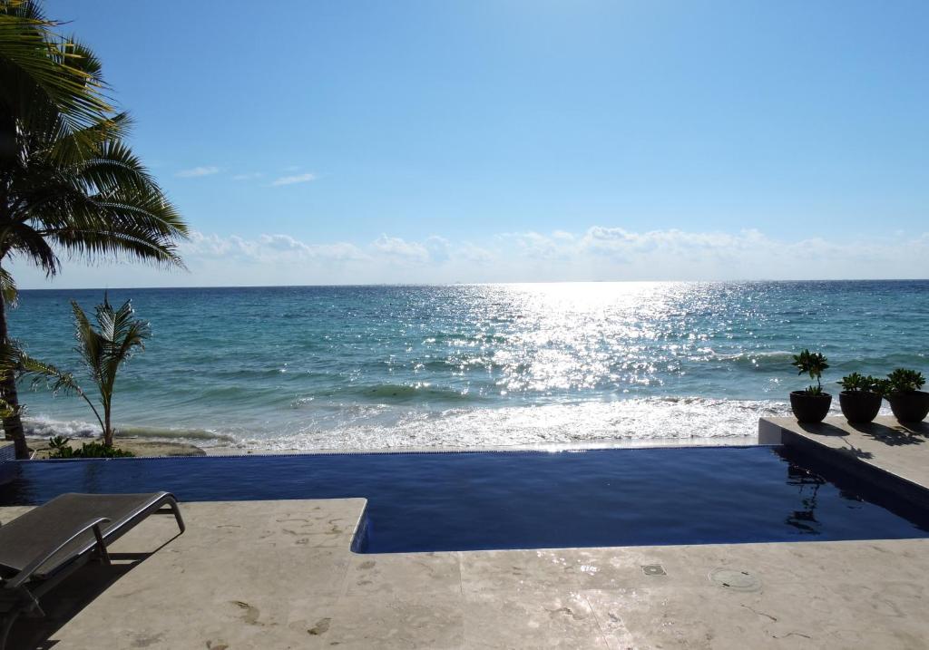 a view of the ocean from a resort patio at Casa Moskito in Playa del Carmen