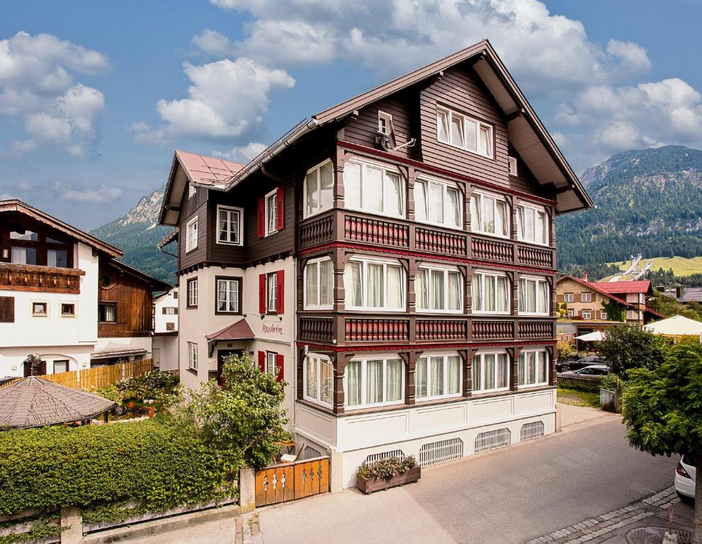 a large building with red and white windows at Gästehaus Maxheim in Oberstdorf