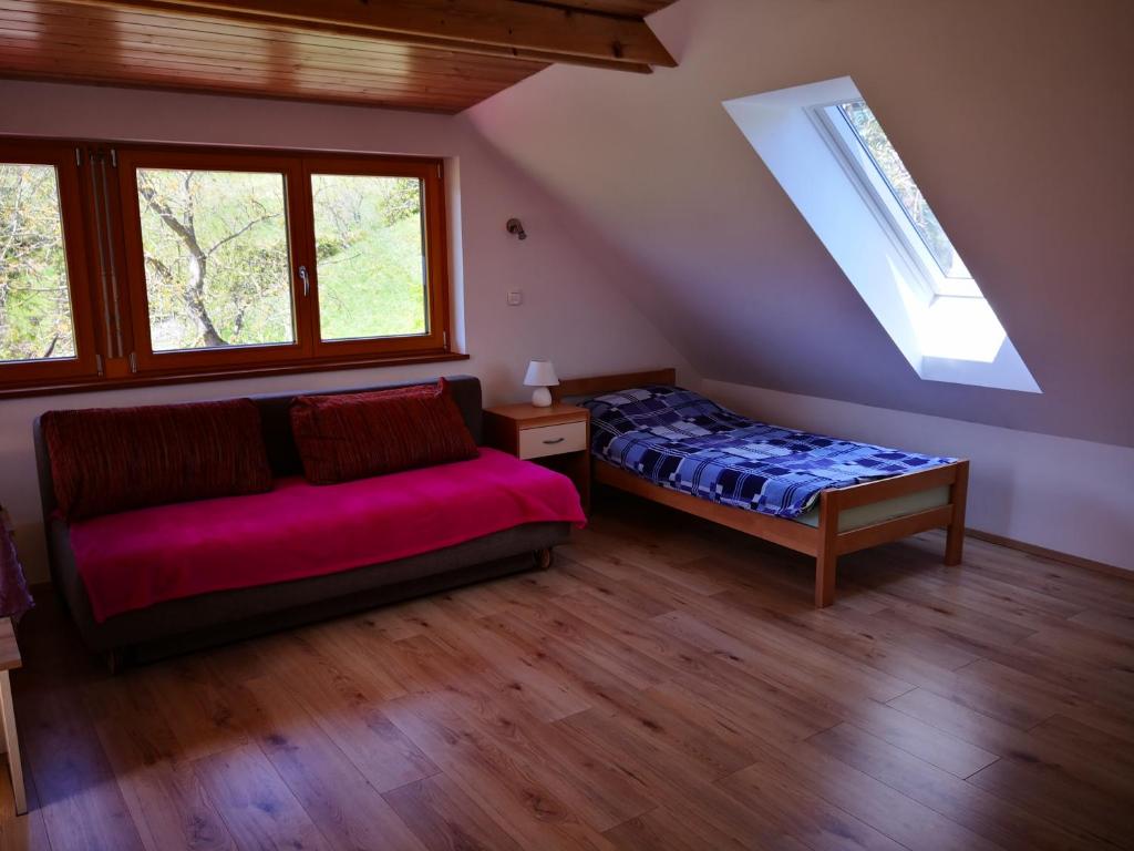 a bedroom with a couch and a bed in a room at Apartments Bernarda in Bled