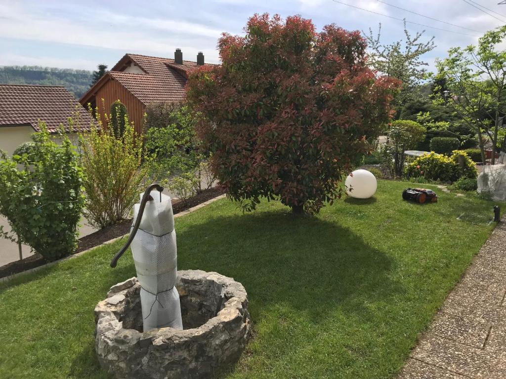 a statue of a penguin standing in a garden at Kleine Wohnung mit schönem Blick in die Schweiz - Grenznah in Murg