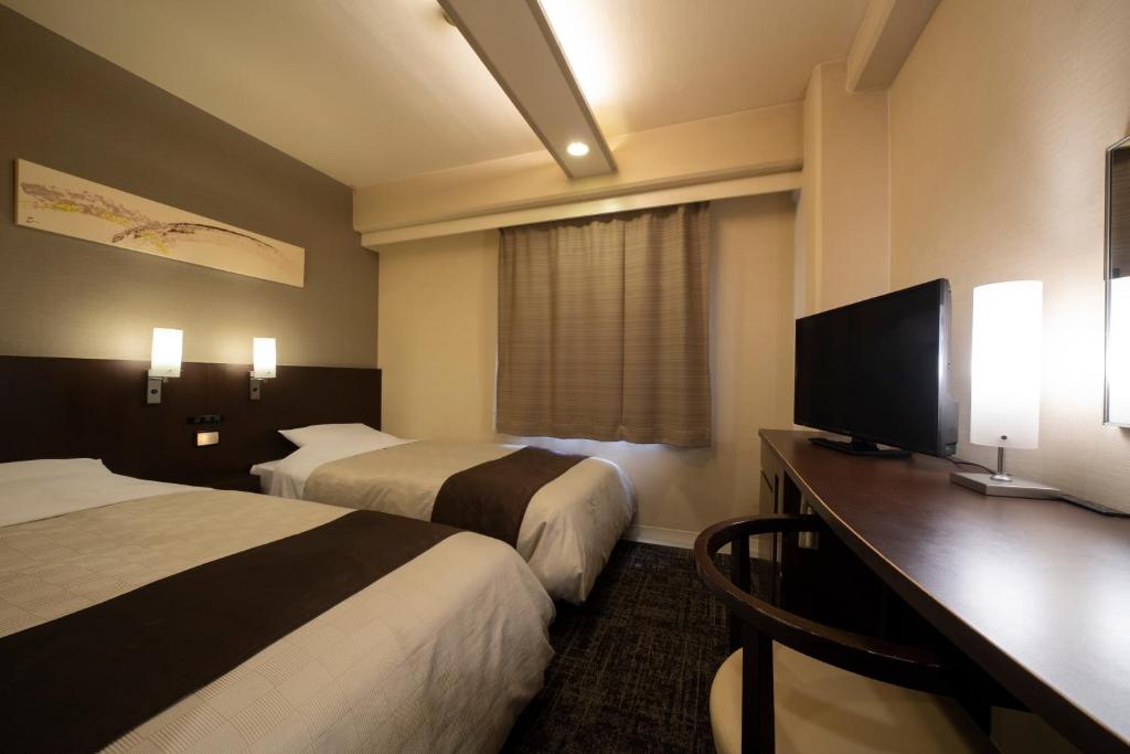 Postel nebo postele na pokoji v ubytování Hotel Binario Umeda