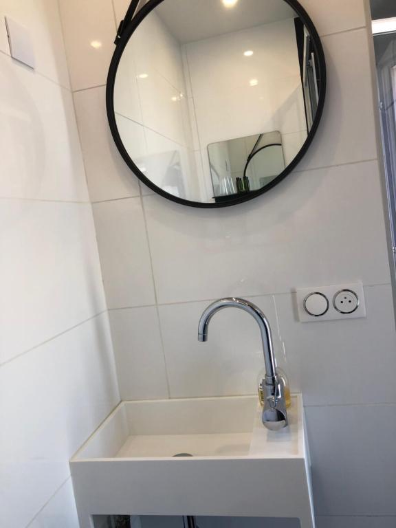 a bathroom with a sink and a mirror at Hôtel Le Mistral in Marseille