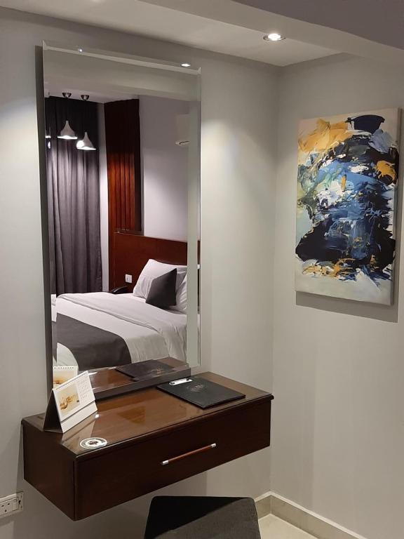Postel nebo postele na pokoji v ubytování Nakhil Inn Residence