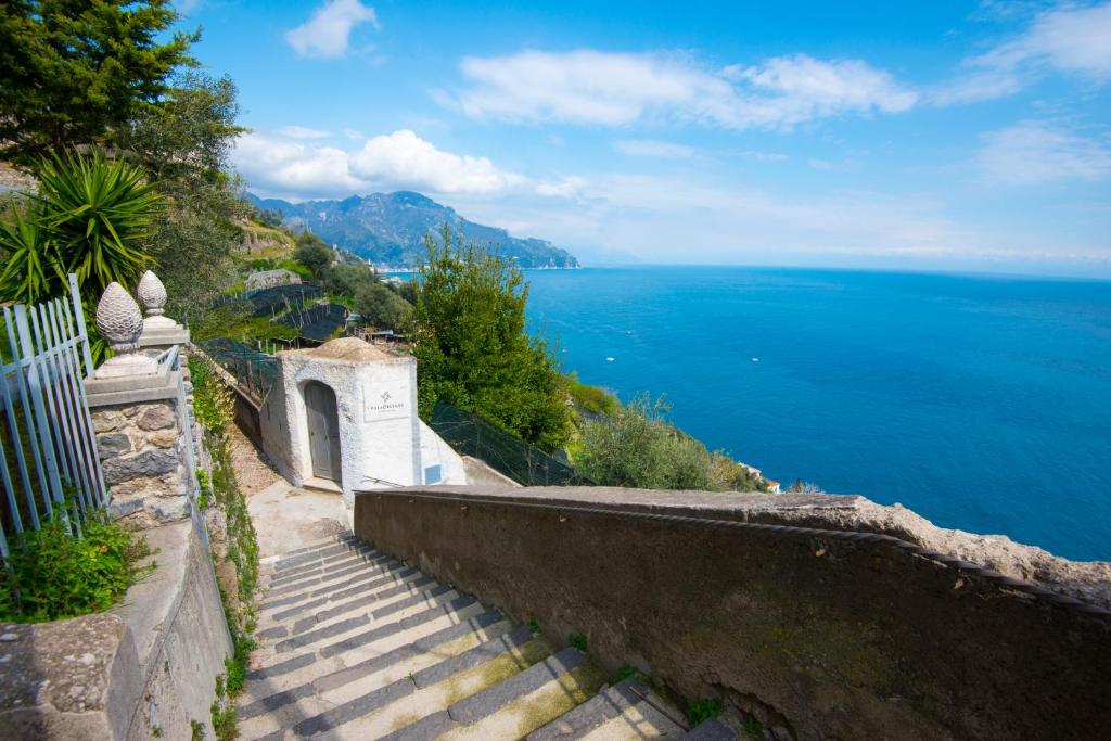 a set of stairs leading down to the ocean at villa orleans in Amalfi