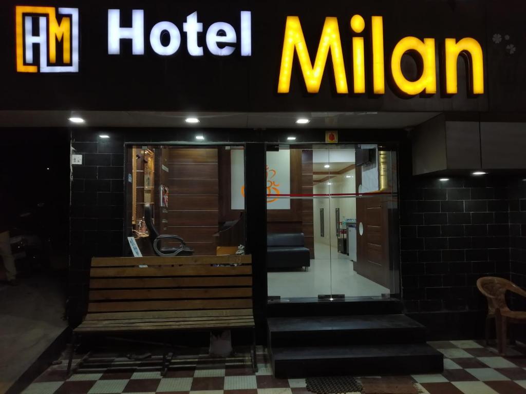 a hotel with a bench in front of a building at Hotel Milan in Dwarka