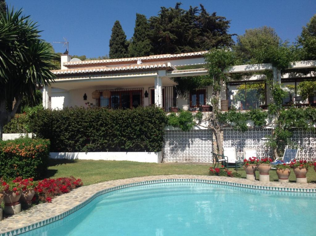 a house with a swimming pool in front of it at villaquinta in La Herradura