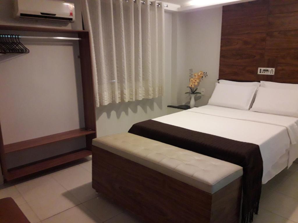 Postel nebo postele na pokoji v ubytování Hotel Sempre Executive