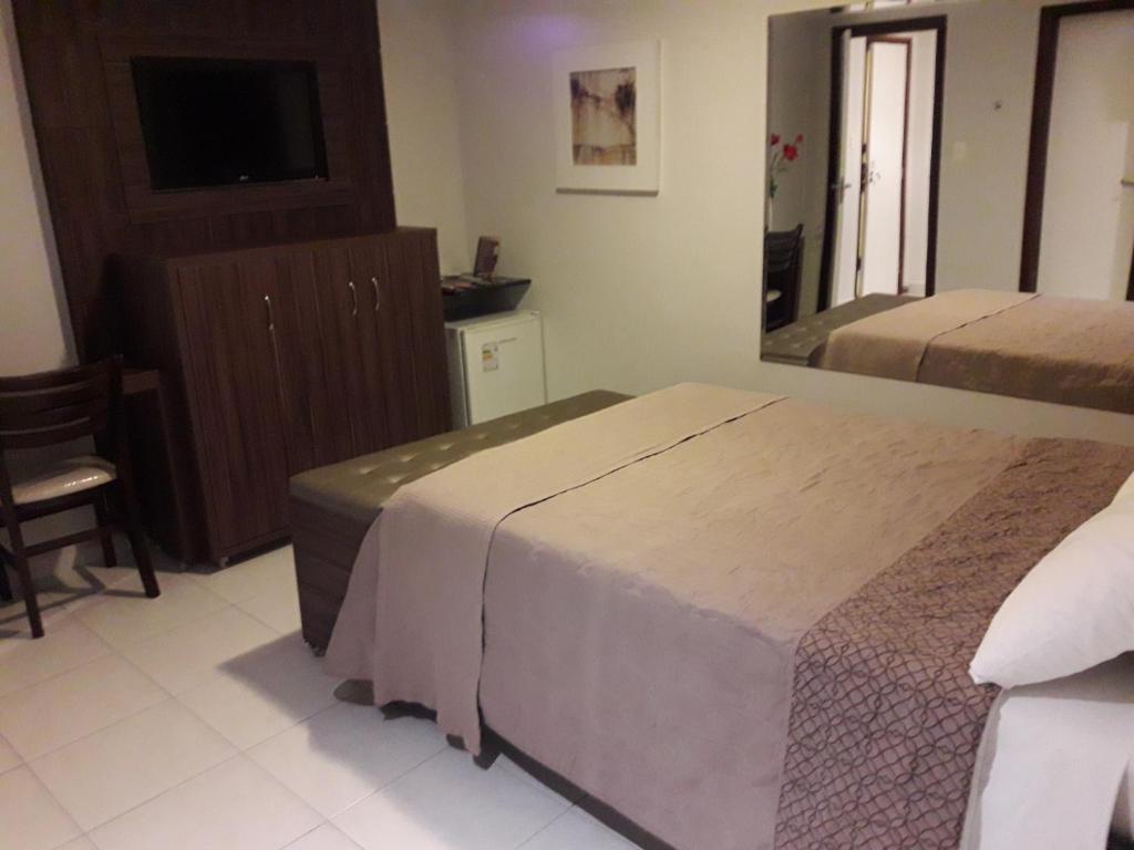 Postel nebo postele na pokoji v ubytování Hotel Sempre Executive