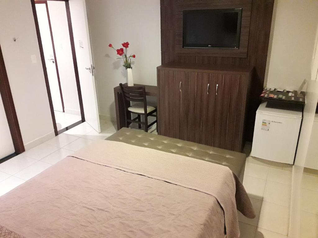 Postel nebo postele na pokoji v ubytování Hotel Sempre Executive