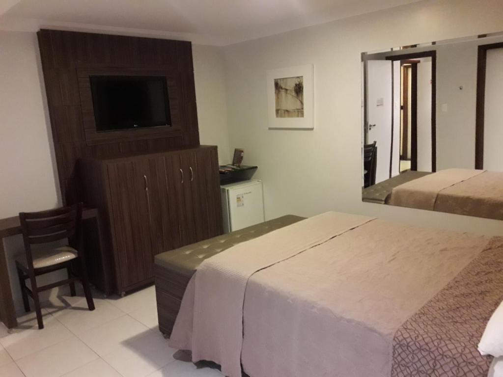 Postel nebo postele na pokoji v ubytování Hotel Sempre Executive