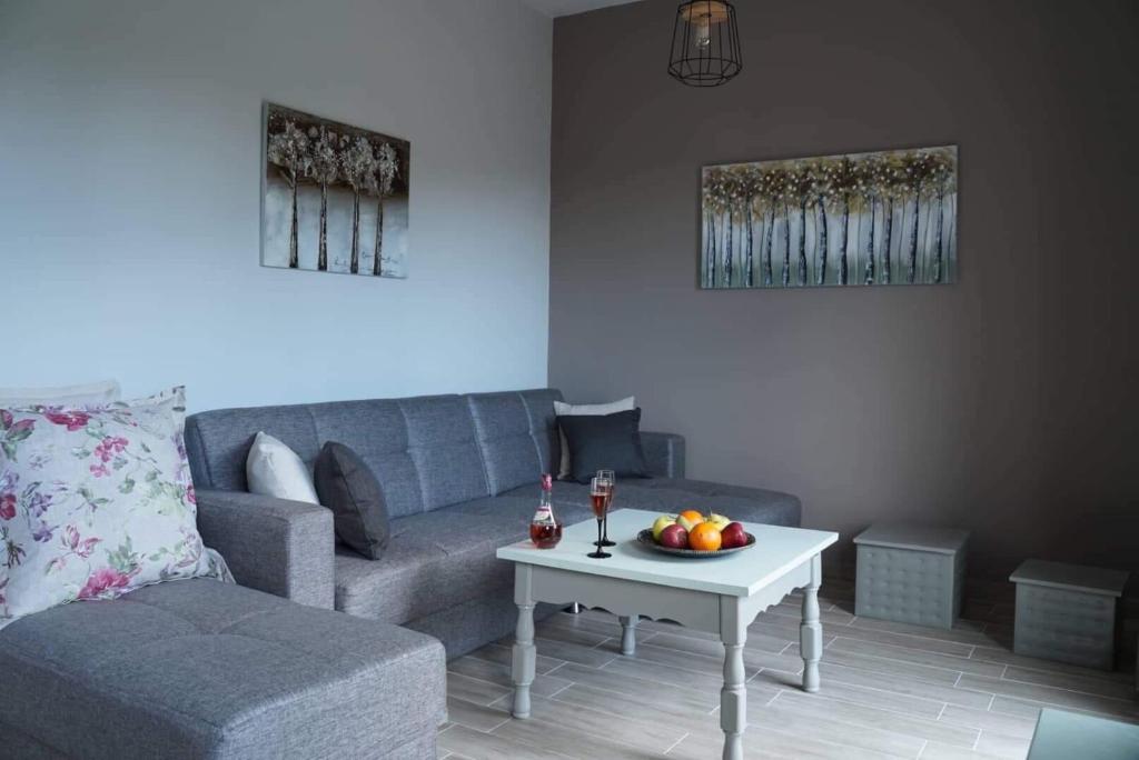 un soggiorno con divano e tavolo con frutta di InGreen apartment a Potamiá