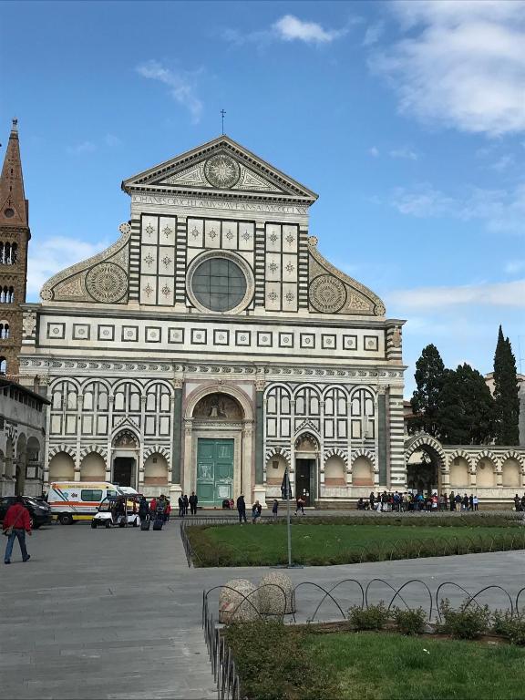 a large building with a clock on top of it at B&B Kingsman in Florence