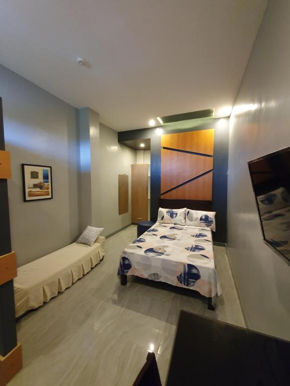 Postel nebo postele na pokoji v ubytování Felicidad Resto and Pension House