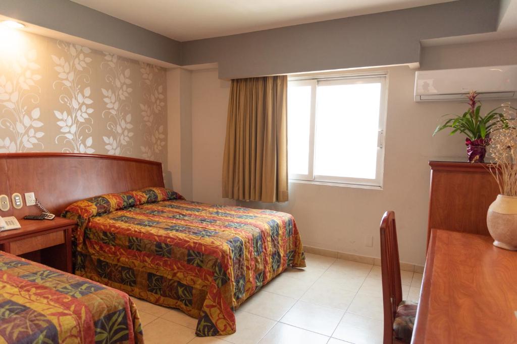 Postel nebo postele na pokoji v ubytování Hotel Impala Veracruz