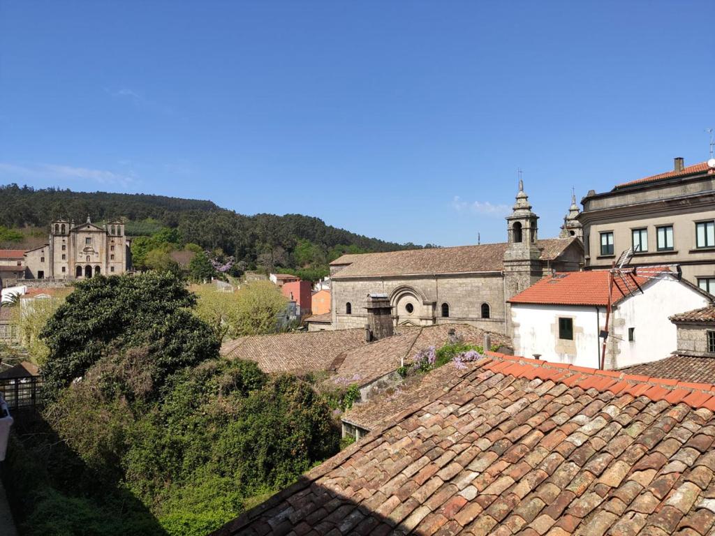 a group of roofs in a town with buildings at A Barca de Pedra in Padrón